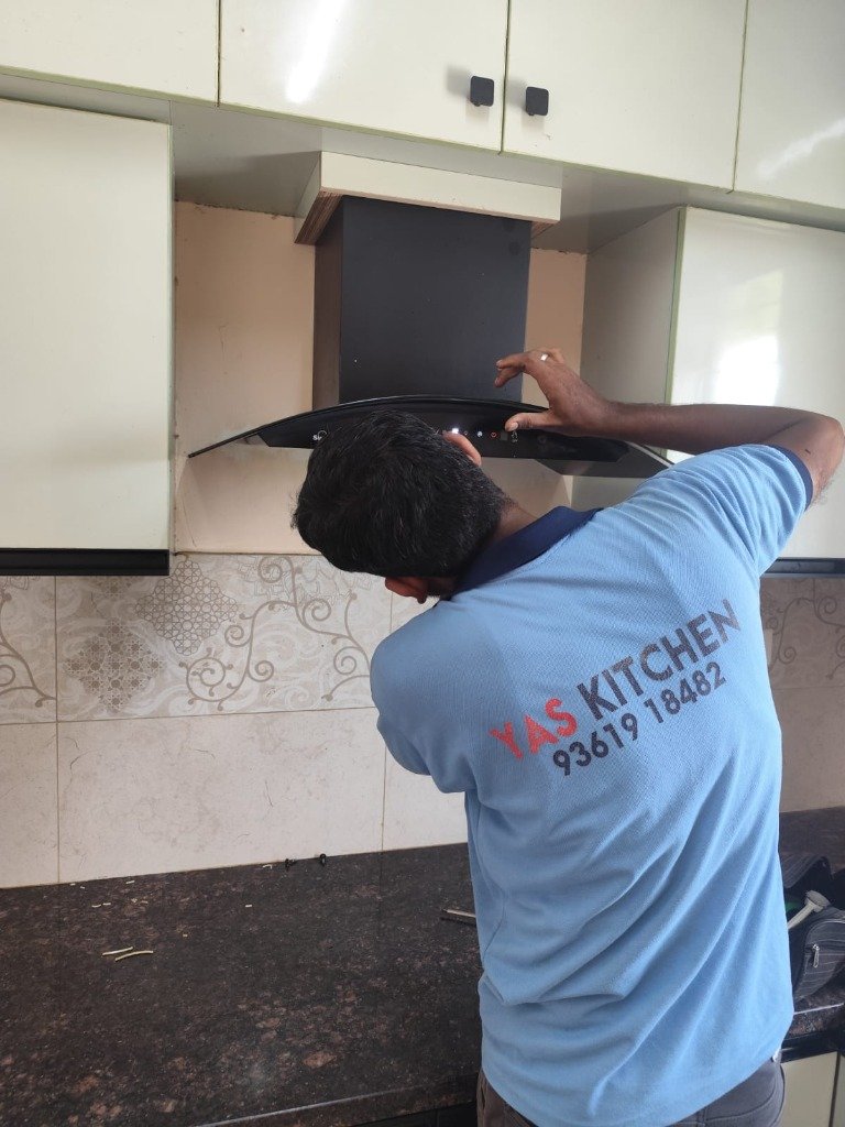 YAS Kitchen Service Technician repairing a chimney hood